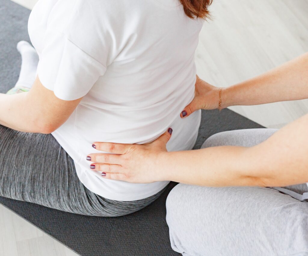 Doula and pregnant woman, doula making massage